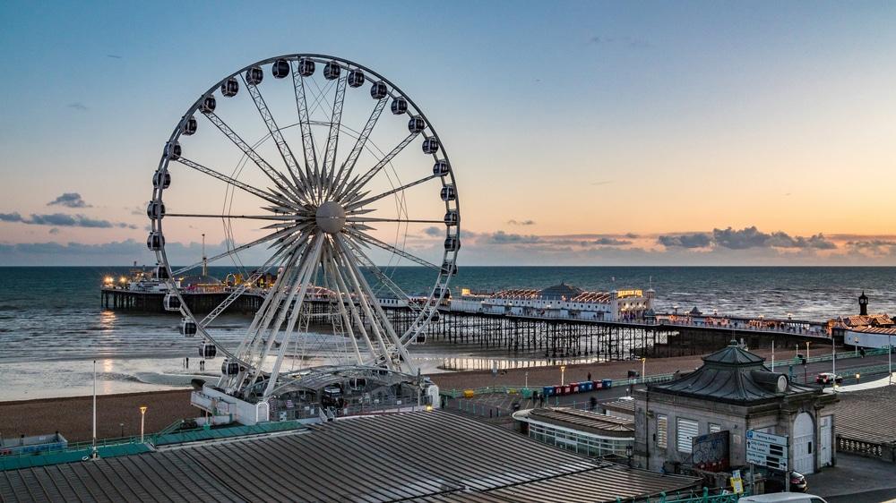 The famous Brighton pier with a Ferris wheel in front of it