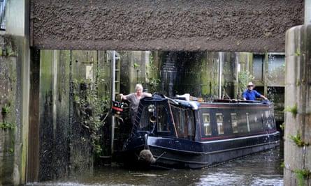 A narrowboat navigates the lock at Denver Sluice.